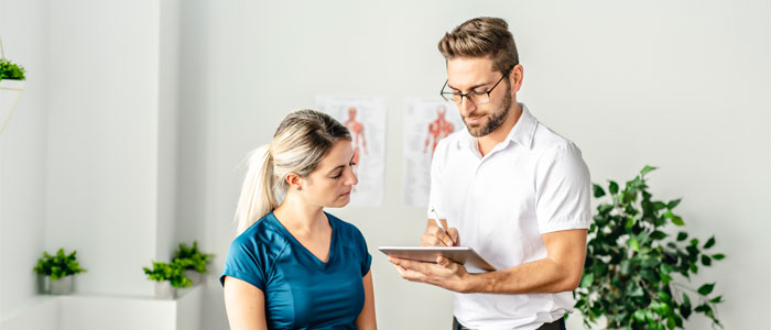 chiropractor discussing overall wellness with patient