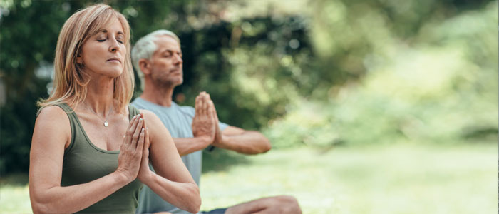 a man and a women meditating 